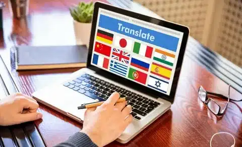 A multilingual specialist is using a translation application on a laptop, symbolizing the diverse language capabilities that support AI&GB's Expert Technical and Academic Consulting Services.