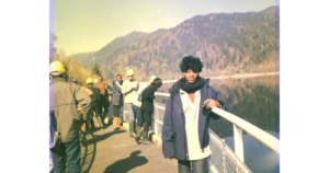 Dr. Armelle Malcomb standing on a bridge in Strasbourg, symbolizing the engineering journey behind the Resilience Coefficient.