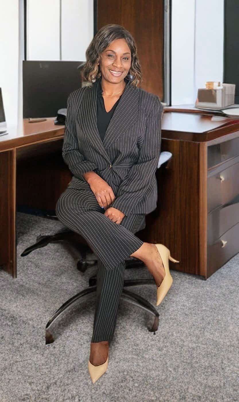 About Us: Dr. Armelle Malcomb, Ph.D. Civil Engineer and Founder of AI&GB Consulting LLC, seated in an executive office. She provides elite Enterprise PMO, EVM, and heavy civil infrastructure consulting services.