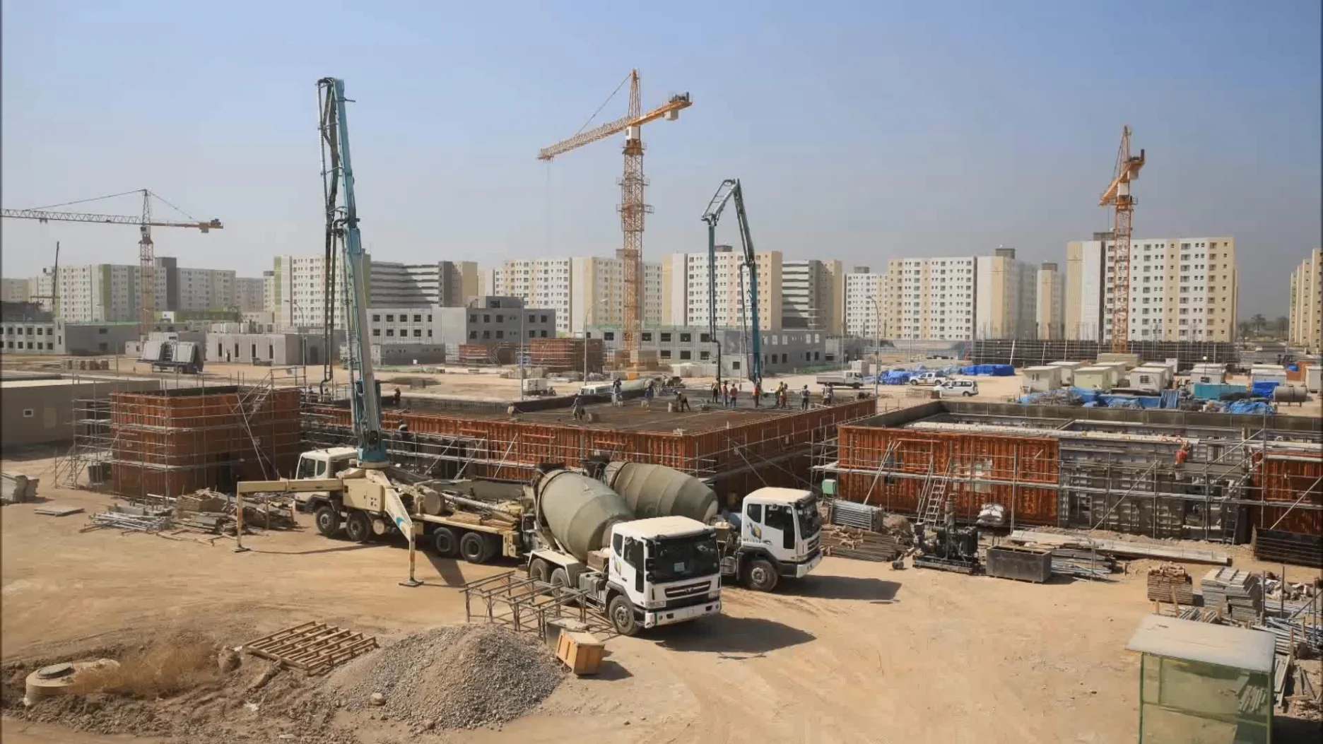A construction site with buildings and workers, symbolizing the large-scale infrastructure projects that benefit from AI&GB's Technical Training and Staffing solutions.